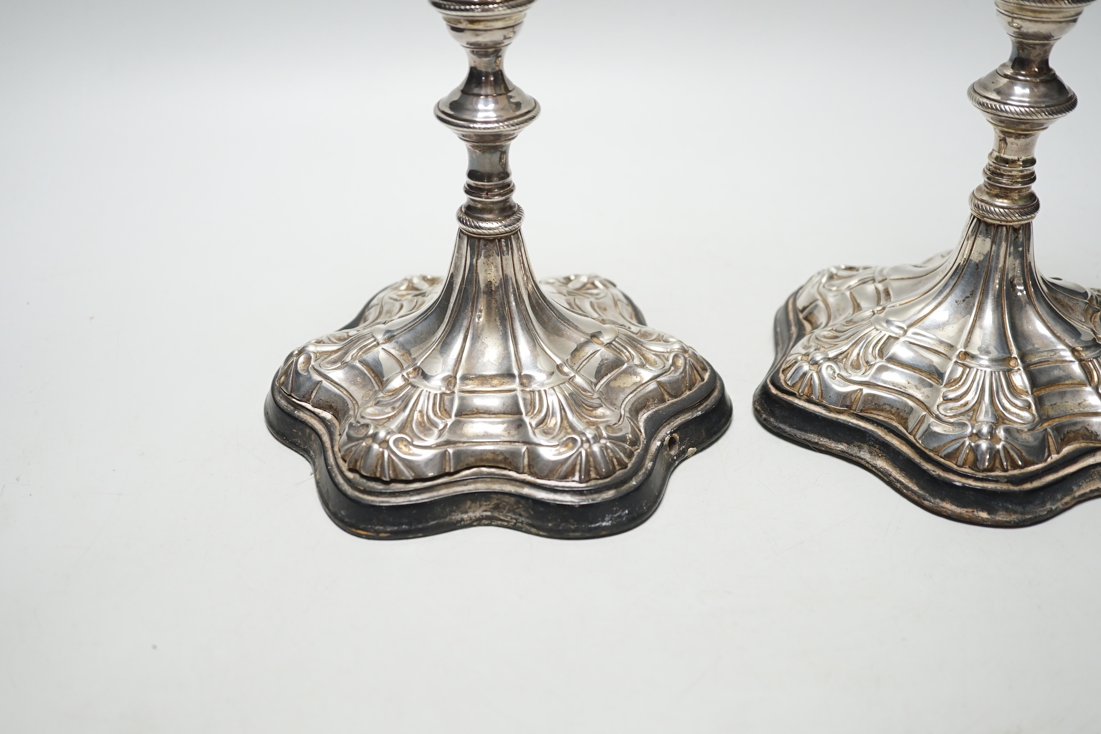 A pair of Georgian? silver candlesticks, on later wooden bases which have been drilled for electricity and later plated? sconces, sticks only, excluding sconces, are 16cm.